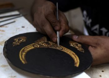 Gold eases as dollar firms after Fed meeting, Powell comments