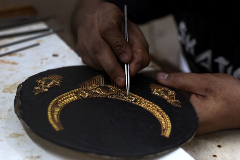 Gold eases as dollar firms after Fed meeting, Powell comments